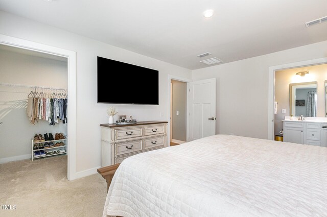 8615 Kenridge Ln, Fuquay Varina, NC 27526 - bedroom with a walk in closet, light carpet, a closet, baseboards, and connected bathroom