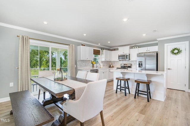 8615 Kenridge Ln, Fuquay Varina, NC 27526 - dining area featuring ornamental molding, light wood-type flooring, recessed lighting, and baseboards