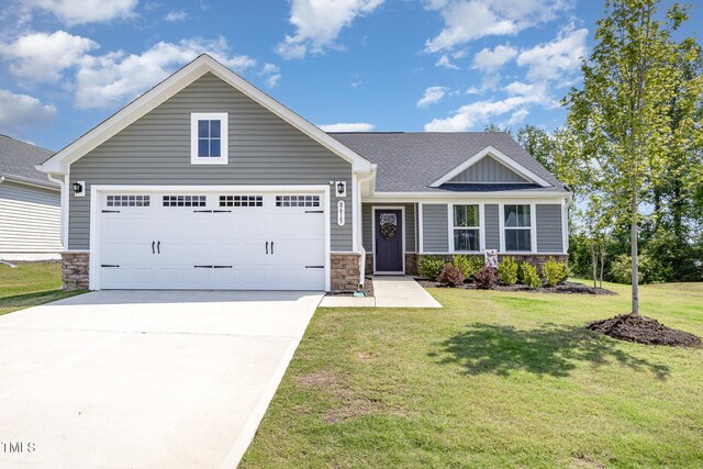 8615 Kenridge Ln, Fuquay Varina, NC 27526 - view of front of property featuring stone siding, concrete driveway, and a front lawn