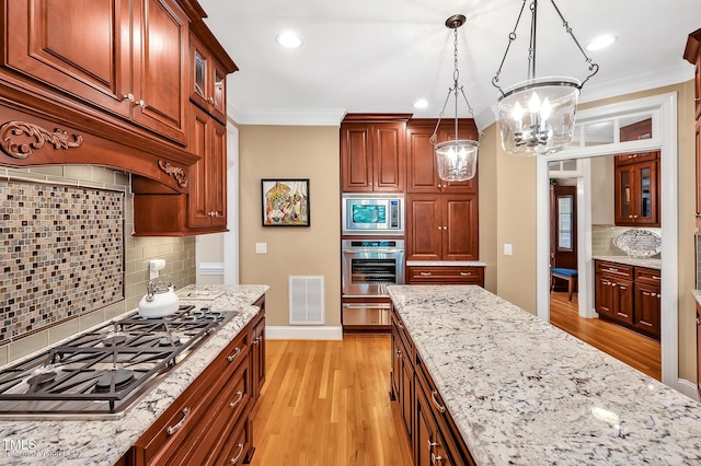 kitchen with stainless steel appliances, backsplash, light wood-style flooring, light stone counters, and crown molding