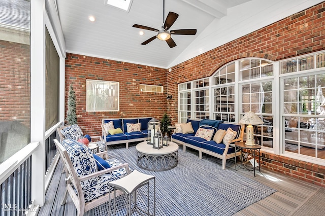 sunroom featuring an outdoor hangout area and a ceiling fan