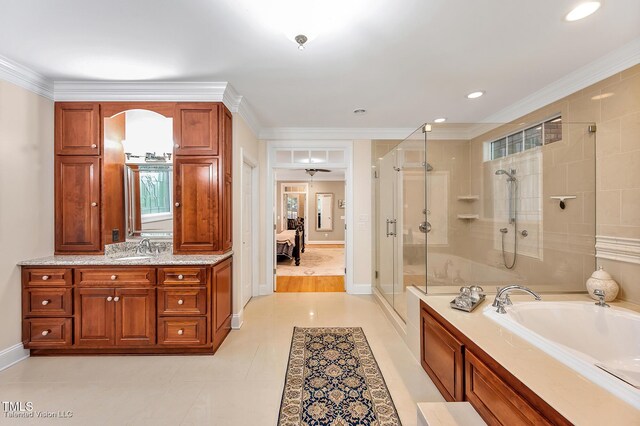 full bathroom featuring ensuite bathroom, a shower stall, a garden tub, vanity, and baseboards