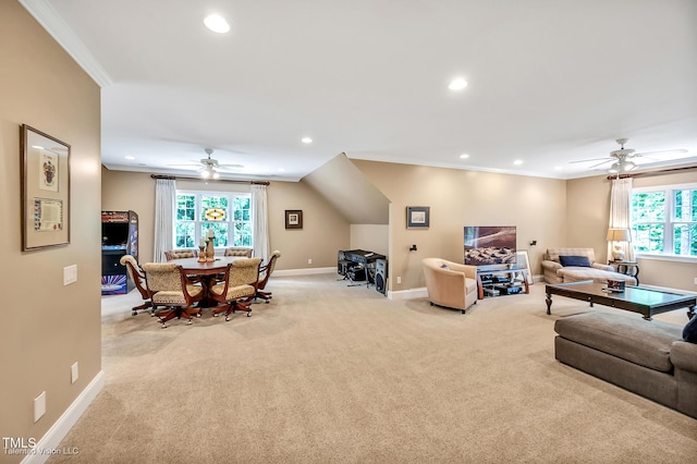 living area featuring a ceiling fan, recessed lighting, crown molding, baseboards, and light colored carpet