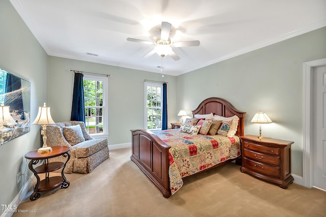 bedroom with light colored carpet, baseboards, ornamental molding, and a ceiling fan
