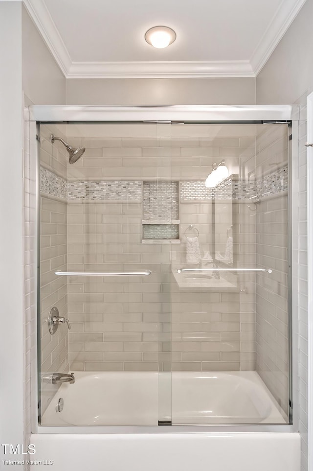 full bathroom with ornamental molding and bath / shower combo with glass door
