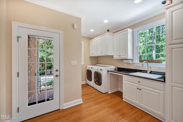 laundry area with independent washer and dryer, cabinet space, ornamental molding, light wood-type flooring, and baseboards