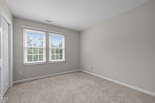 unfurnished bedroom with baseboards, carpet flooring, and a closet