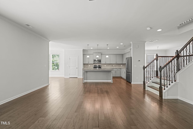 1013 Poppy Fields Ln, Wake Forest, NC 27587 - unfurnished living room with stairs, dark wood finished floors, recessed lighting, and ornamental molding