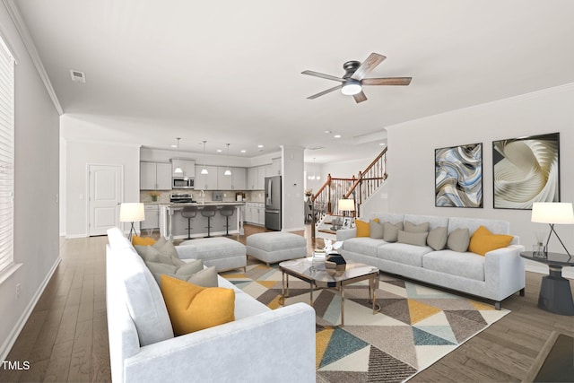 1013 Poppy Fields Ln, Wake Forest, NC 27587 - living room featuring stairs, a ceiling fan, wood finished floors, recessed lighting, and crown molding