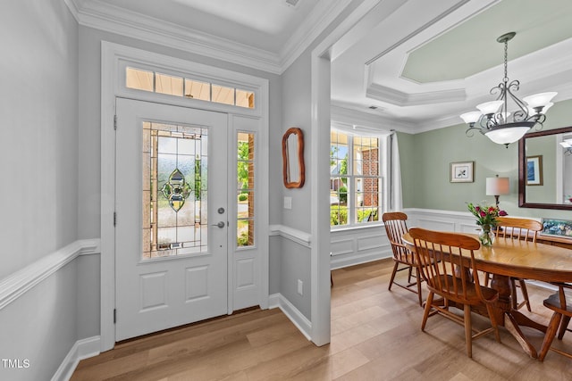 232 Shady Hollow Ln, Garner, NC 27529 - entryway featuring a chandelier, light wood-type flooring, crown molding, and a wainscoted wall