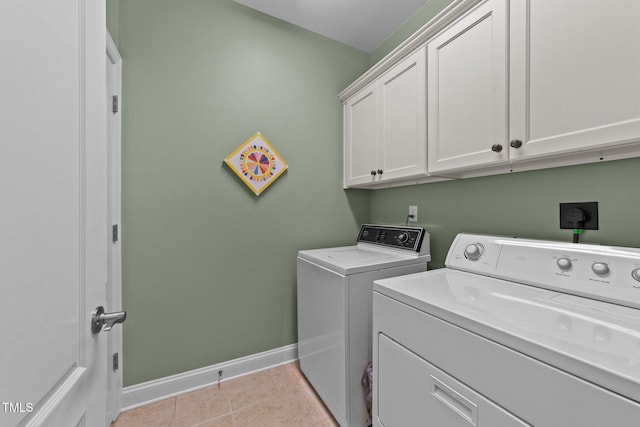 232 Shady Hollow Ln, Garner, NC 27529 - laundry area featuring cabinet space, washer and dryer, baseboards, and light tile patterned floors