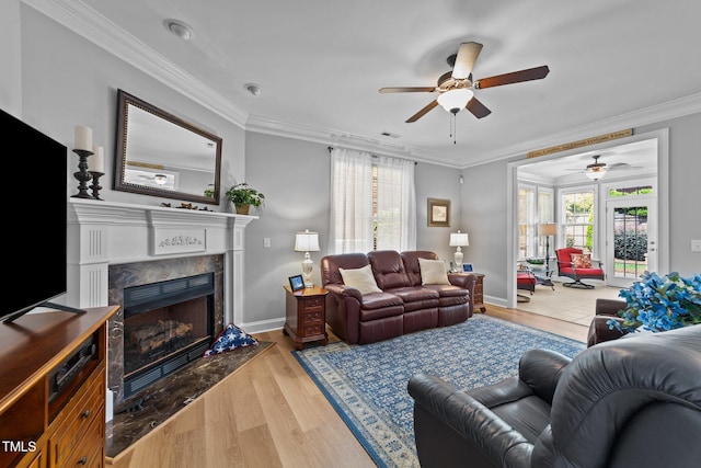 232 Shady Hollow Ln, Garner, NC 27529 - living area with a ceiling fan, a fireplace, ornamental molding, wood finished floors, and baseboards