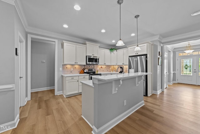 232 Shady Hollow Ln, Garner, NC 27529 - kitchen featuring stainless steel appliances, white cabinets, light wood-style flooring, crown molding, and recessed lighting