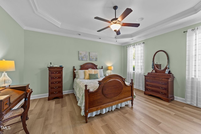 232 Shady Hollow Ln, Garner, NC 27529 - bedroom with a raised ceiling, light wood-style flooring, crown molding, baseboards, and a ceiling fan