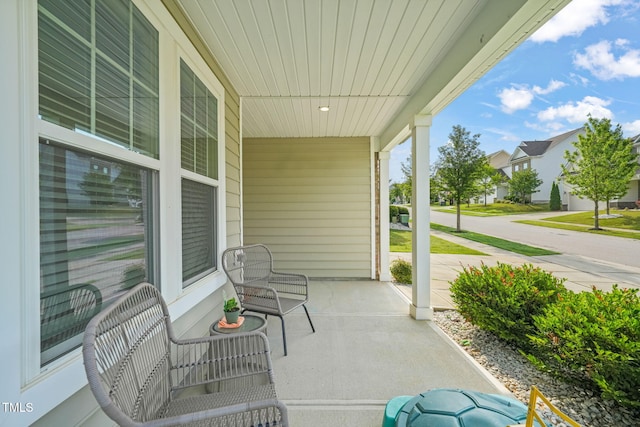 view of patio featuring covered porch and a residential view