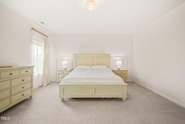 bedroom featuring light colored carpet