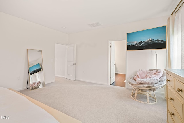 bedroom with light carpet and baseboards