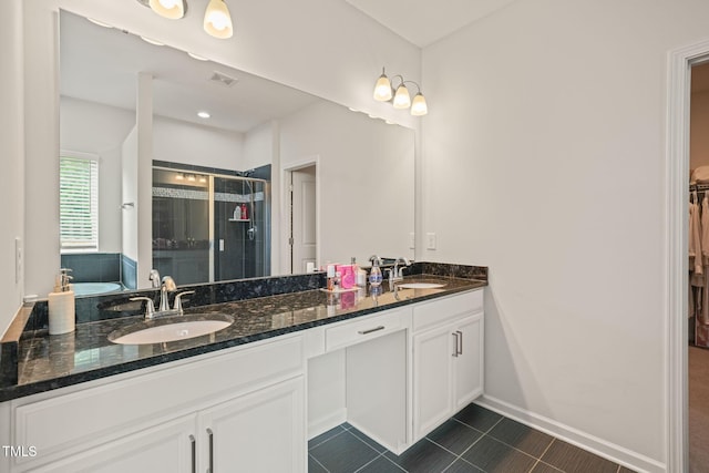 bathroom featuring a stall shower, tile patterned floors, double vanity, baseboards, and a bath