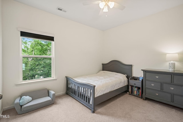 bedroom featuring light colored carpet, ceiling fan, and baseboards