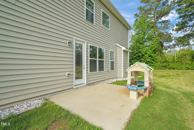 back of property with a patio and a yard