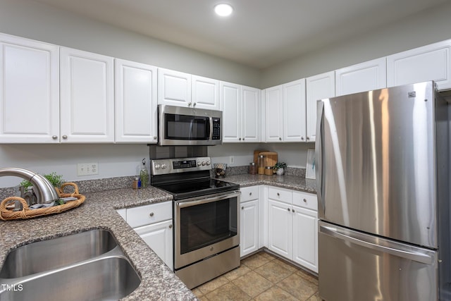 9305 Dominion Blvd, Raleigh, NC 27617 - kitchen with stainless steel appliances, white cabinets, recessed lighting, and light stone finish flooring