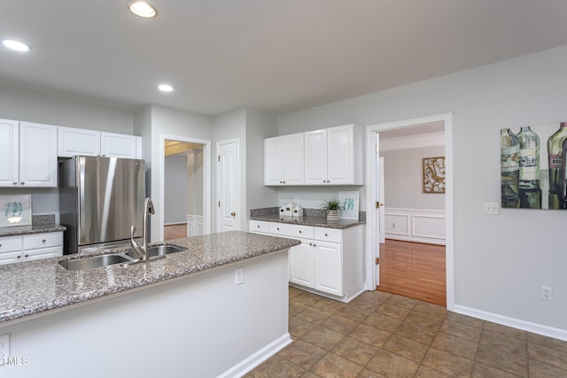 9305 Dominion Blvd, Raleigh, NC 27617 - kitchen with freestanding refrigerator, white cabinets, recessed lighting, and dark stone counters