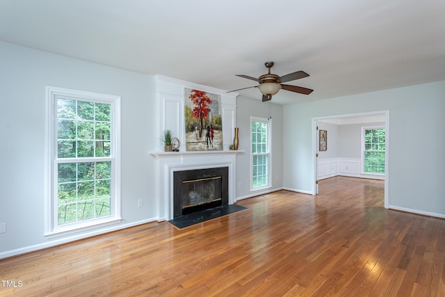 9305 Dominion Blvd, Raleigh, NC 27617 - unfurnished living room featuring ceiling fan, wood finished floors, and a fireplace with flush hearth