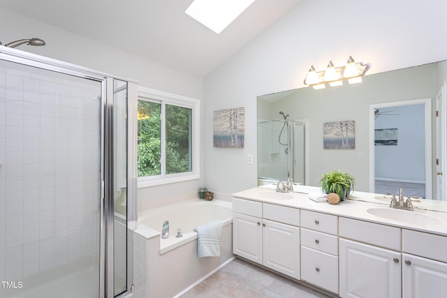 9305 Dominion Blvd, Raleigh, NC 27617 - full bathroom with a stall shower, double vanity, lofted ceiling, a garden tub, and a skylight