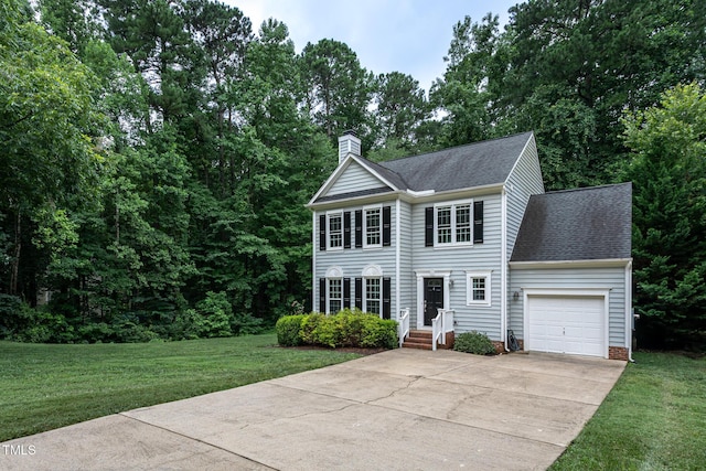 9305 Dominion Blvd, Raleigh, NC 27617 - colonial inspired home featuring an attached garage, a chimney, concrete driveway, roof with shingles, and a front yard
