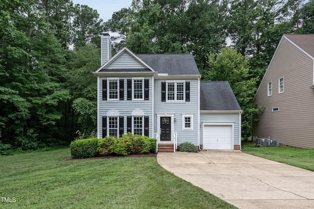 9305 Dominion Blvd, Raleigh, NC 27617 - colonial-style house featuring an attached garage, a chimney, concrete driveway, a shingled roof, and a front lawn