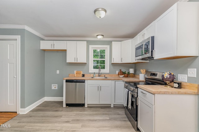 4420 W River Rd, Franklinton, NC 27525 - kitchen with stainless steel appliances, a sink, white cabinets, light wood-style flooring, and wooden counters