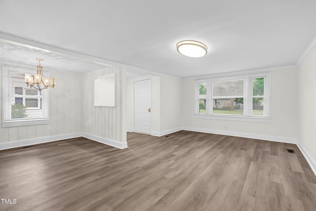 313 W Church St, Angier, NC 27501 - empty room with a chandelier, baseboards, wood finished floors, and crown molding