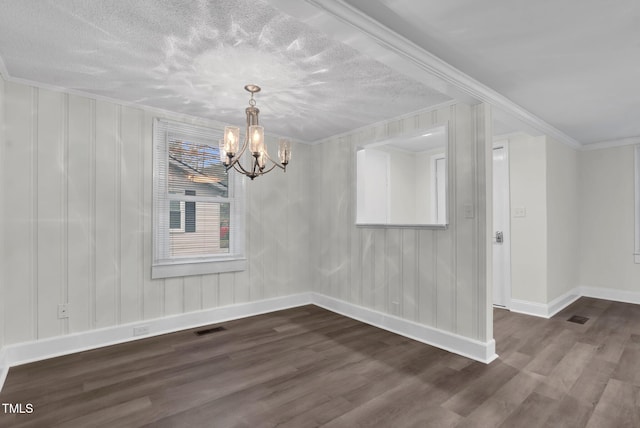 313 W Church St, Angier, NC 27501 - unfurnished dining area featuring baseboards, a chandelier, dark wood-style floors, ornamental molding, and a textured ceiling