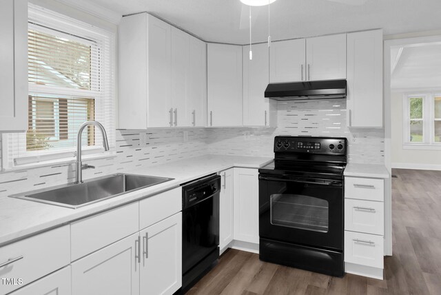 313 W Church St, Angier, NC 27501 - kitchen featuring black appliances, under cabinet range hood, a sink, and light countertops