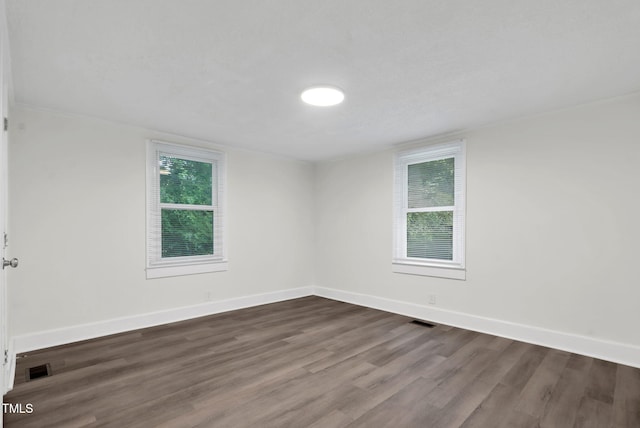 313 W Church St, Angier, NC 27501 - empty room with dark wood-type flooring and baseboards