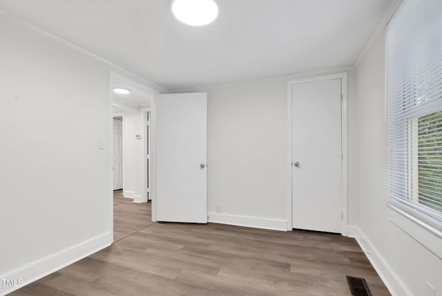 313 W Church St, Angier, NC 27501 - unfurnished bedroom with wood finished floors and baseboards