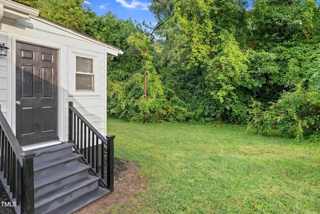 313 W Church St, Angier, NC 27501 - view of green lawn featuring entry steps and view of wooded area