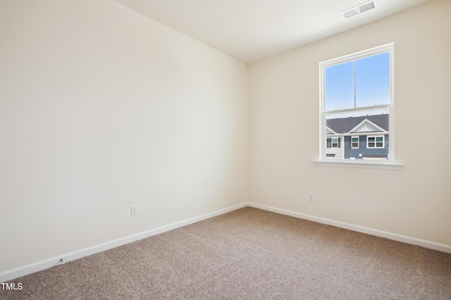 carpeted spare room with baseboards