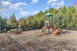 community play area featuring a view of trees