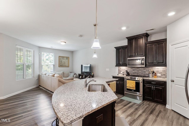 174 Walking Path Pl, Hillsborough, NC 27278 - kitchen with appliances with stainless steel finishes, a sink, dark wood-type flooring, open floor plan, and tasteful backsplash