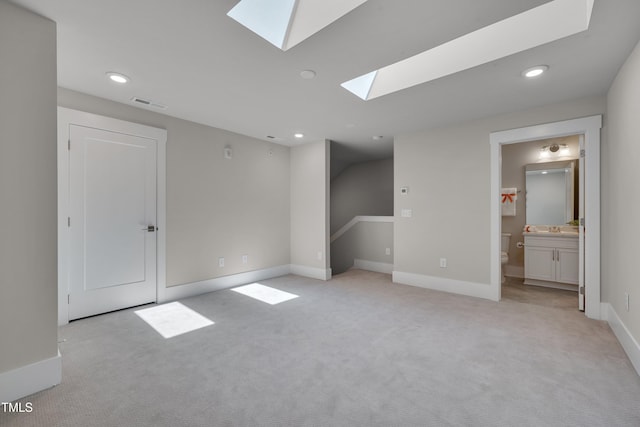 10330 Sablewood Dr Unit 104, Raleigh, NC 27617 - unfurnished bedroom with a skylight, light colored carpet, recessed lighting, and ensuite bathroom