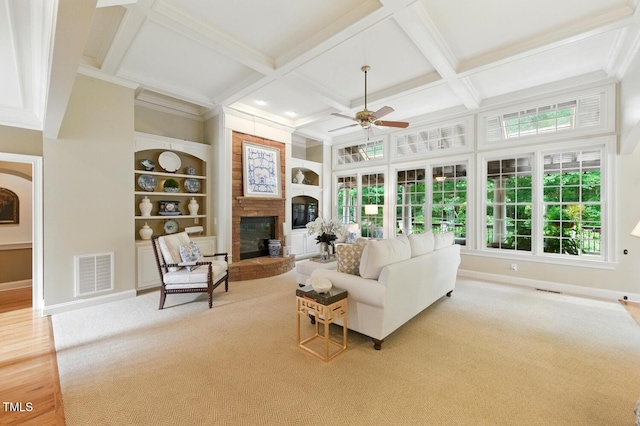 671 Bear Tree Crk, Chapel Hill, NC 27517 - carpeted living area with a glass covered fireplace, ceiling fan, built in features, coffered ceiling, and beamed ceiling