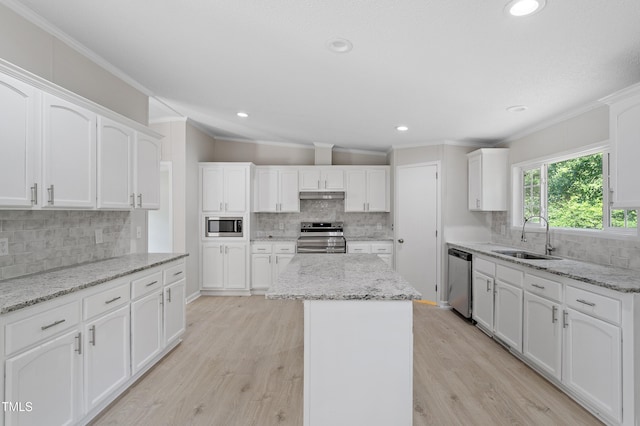 125 Hillcreek Dr, Parkton, NC 28371 - kitchen with stainless steel appliances, a sink, ornamental molding, decorative backsplash, and under cabinet range hood