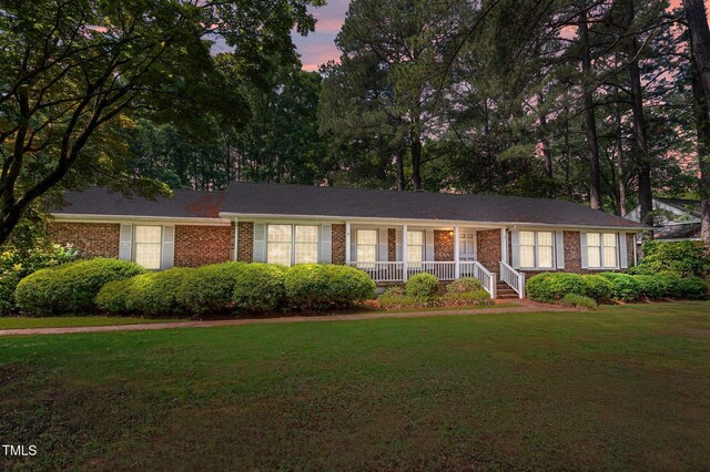 2610 N Main St, Tarboro, NC 27886 - ranch-style home featuring covered porch, a lawn, and brick siding