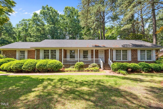 2610 N Main St, Tarboro, NC 27886 - ranch-style home with a porch, brick siding, and a front lawn