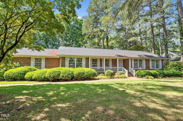 2610 N Main St, Tarboro, NC 27886 - ranch-style home featuring a front yard, a porch, and brick siding