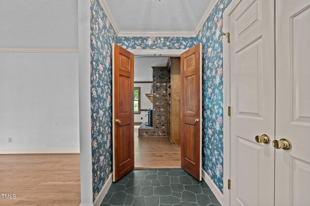 2610 N Main St, Tarboro, NC 27886 - foyer entrance with wallpapered walls, baseboards, crown molding, and dark wood-type flooring
