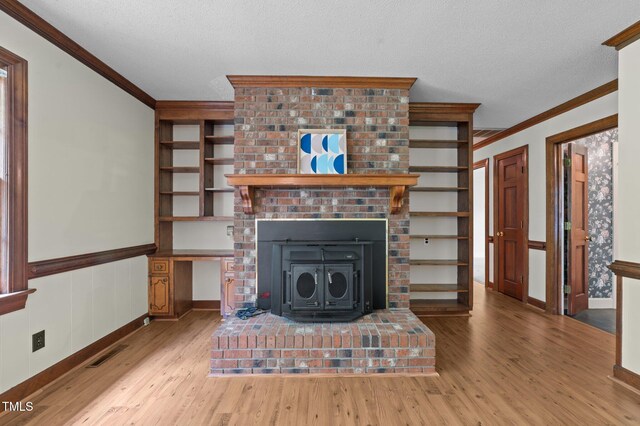 2610 N Main St, Tarboro, NC 27886 - living room featuring wood finished floors, ornamental molding, a brick fireplace, a textured ceiling, and a wainscoted wall