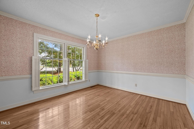2610 N Main St, Tarboro, NC 27886 - spare room featuring ornamental molding, wallpapered walls, a chandelier, and hardwood / wood-style flooring