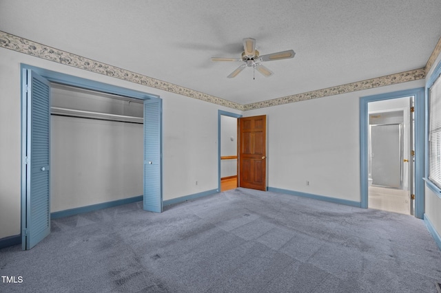 2610 N Main St, Tarboro, NC 27886 - unfurnished bedroom with baseboards, a closet, carpet, a textured ceiling, and ceiling fan